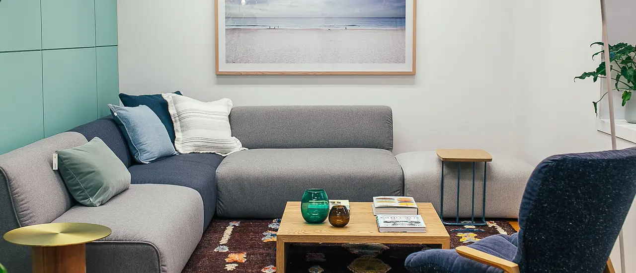 Sectional sofa and armchair under a lamp